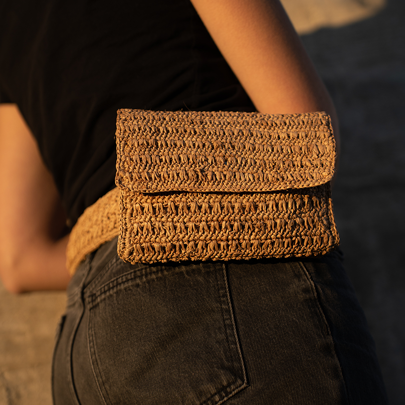 une femme avec une pochette beige portée à la ceinture Bagatelle France